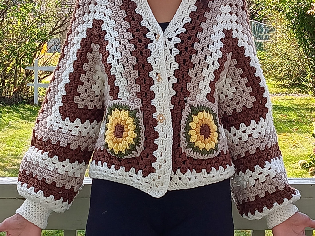 Kiera Monet crocheted jacket with flower design on the pockets, puffy sleeves and fitted cuff.