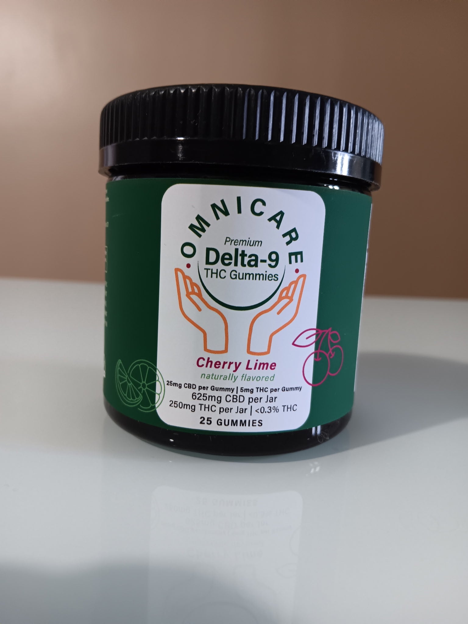 Cherry Lime Gummies with 25mg CBD + 5mg Delta-9 THC per gummy on a white surface and beige background.