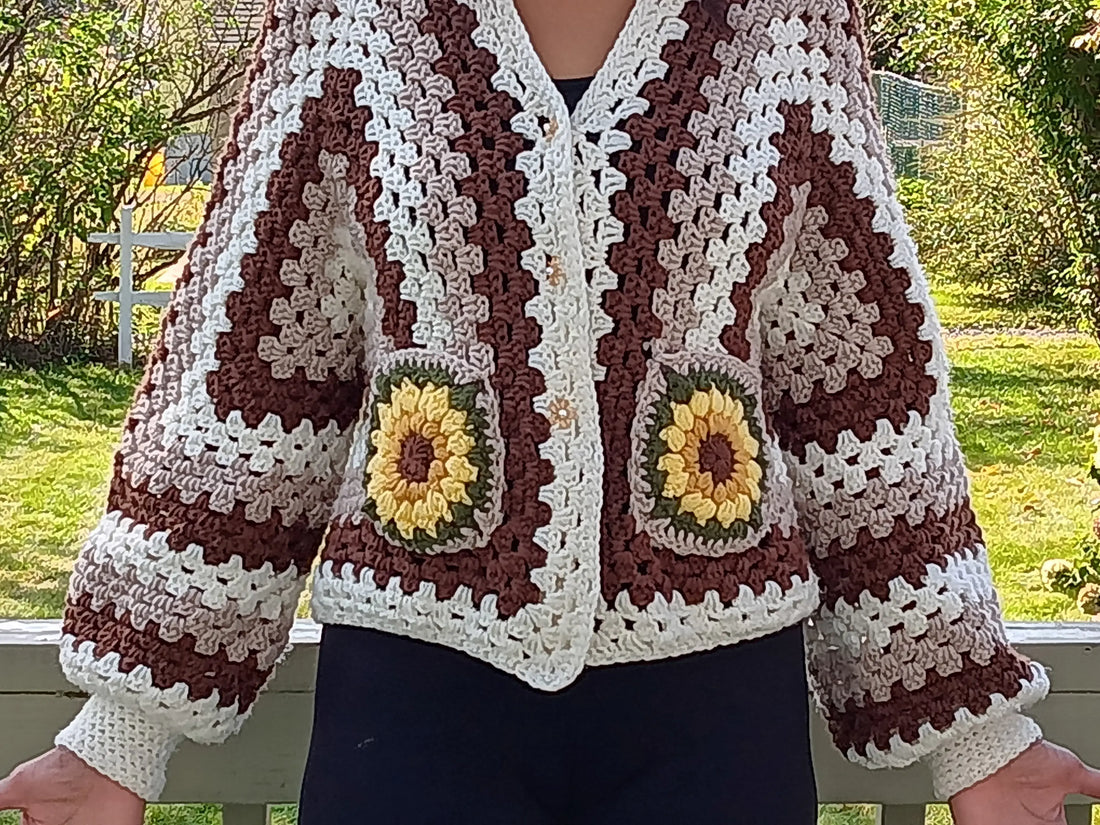Kiera Monet crocheted jacket with flower design on the pockets, puffy sleeves and fitted cuff. 